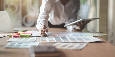 Young professional UI graphic designer choosing colours for their smartphones templates