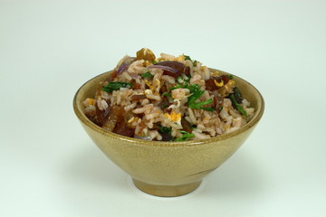 Chinese traditional fried rice with pork and fresh vegetable on the yellow bowl.