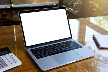 Empty white screen laptop computer on wooden table top, business concept, Notebook mockup design with copy space for text and advertising.