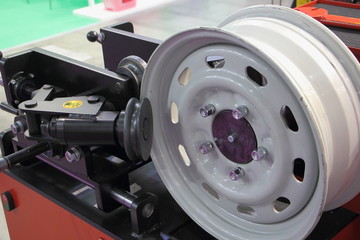 Stainless car wheel on machine tool close up, Straightening of automobile wheels, equipment for car disks repair