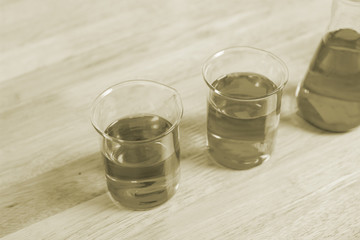 Scientific equipment prepared for the experiment to develop a chemical thread on a wooden table.