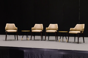 Empty chairs on stage ready for seminar
