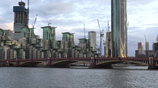Establishing shot of Vauxhall Bridge in London over Thames river , zoom out