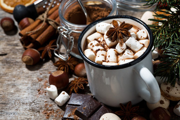 cup of hot chocolate with marshmallows and sweets on wooden background, closeup