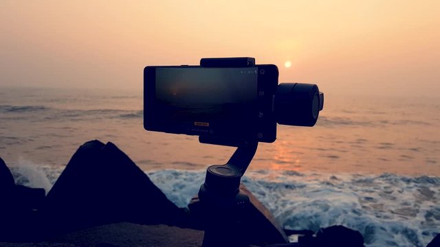 A slow Motion shot of a Mobile gimbal stabilizer capturing a splendid sunrise in the shore of Pondicherry, India