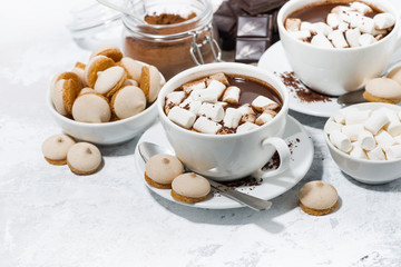 cups of hot chocolate with marshmallows on white table