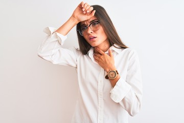Young beautiful businesswoman wearing glasses standing over isolated white background Touching forehead for illness and fever, flu and cold, virus sick