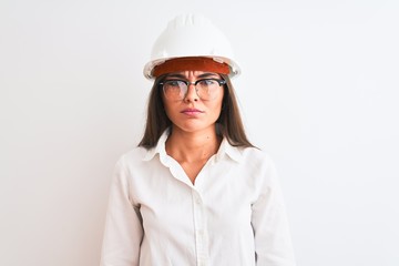 Young beautiful architect woman wearing helmet and glasses over isolated white background skeptic and nervous, frowning upset because of problem. Negative person.