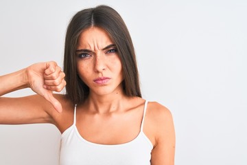 Young beautiful woman wearing casual t-shirt standing over isolated white background with angry...