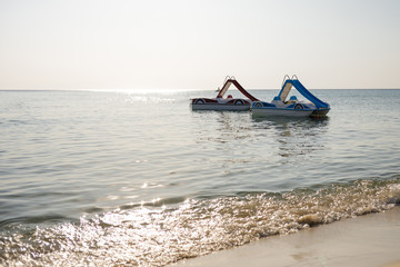 Fototapeta premium two catamaran on the water. Pedal boat at sea . Summer vacation.
