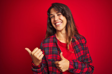 Young beautiful woman wearing casual jacket standing over red isolated background Suffering of backache, touching back with hand, muscular pain