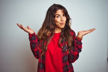 Young beautiful woman wearing red t-shirt and jacket standing over white isolated background...