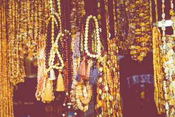 Amber pendants and necklaces at the street market of Curonian Spit, Kaliningrad region, Russia.