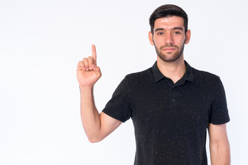 Fototapeta premium Portrait of young bearded Persian man pointing up