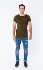 Obraz premium Full body of happy young handsome Persian man smiling