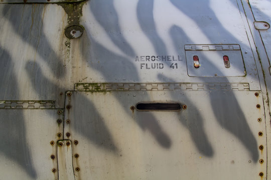 Texture of old jet plane with tiger camouflage and Aeroshell fluid reservoir