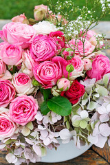 Beautiful floral arrangement with pink roses, hortensia and gypsophila paniculata