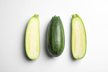 Fresh ripe green zucchinis on white background, top view