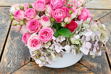 Beautiful floral arrangement with pink roses, hortensia and gypsophila paniculata