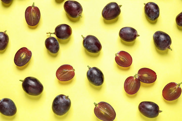 Flat lay composition with fresh ripe juicy grapes on yellow background