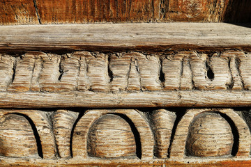 Old wooden carvings on a wooden board.