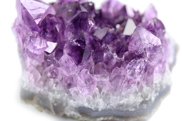 Beautiful purple amethyst gemstone on white background, closeup
