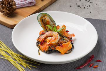 Seafood pasta with clams Spaghetti Vongole on white plate in lighting studio