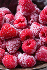 Frozen raspberries on wooden background