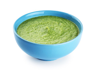 Bowl of green cream soup with pea, broccoli, kale and spinach  isolated on white background.