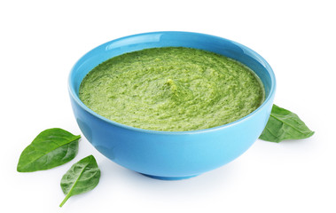 Bowl of green cream soup with pea, broccoli, kale and spinach  isolated on white background.