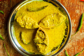 popular Bengali Illish/Hilsa fish curry with grinned mustard seed.