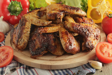 Chicken wings barbecue with different vegetables	