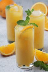 Glasses full of orange juice with ice