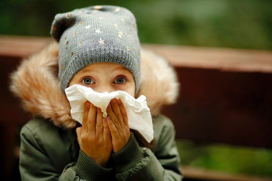 The little girl has a runny nose, colds and diseases season