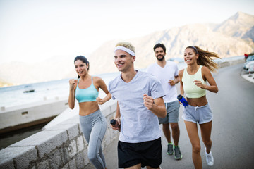 Group of young people jogging and running outdoors in nature