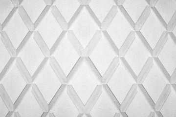 Abstract rhombus shape white and black color background close up, gray concrete wall with diamond texture pattern, grey geometric lozenge backdrop frame, decorative rhomb graphic ornament, copy space