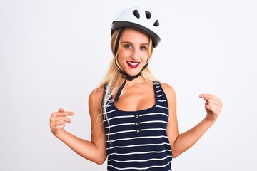 Young beautiful woman wearing bike helmet standing over isolated white background looking confident with smile on face, pointing oneself with fingers proud and happy.