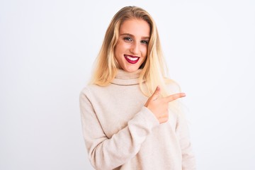 Young beautiful woman wearing turtleneck sweater standing over isolated white background cheerful with a smile of face pointing with hand and finger up to the side with happy and natural