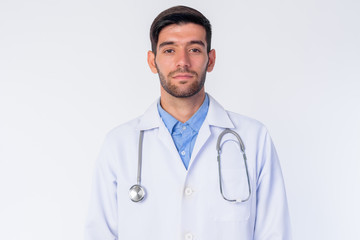 Fototapeta premium Face of young bearded Persian man doctor looking at camera