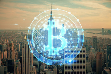 Double exposure of crypto currency theme hologram drawing and city veiw background. Concept of blockchain and bitcoin.