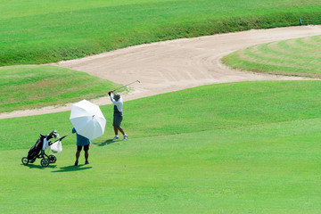 Golfer kicks the ball.