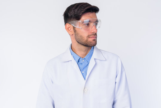 Young bearded Persian man doctor as scientist thinking