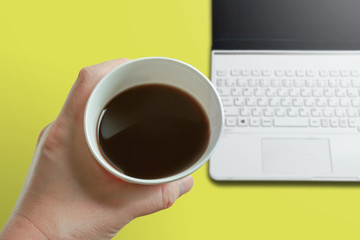 Drinking coffee at the desk or table.   デスクまたはテーブルでコーヒーを飲む。