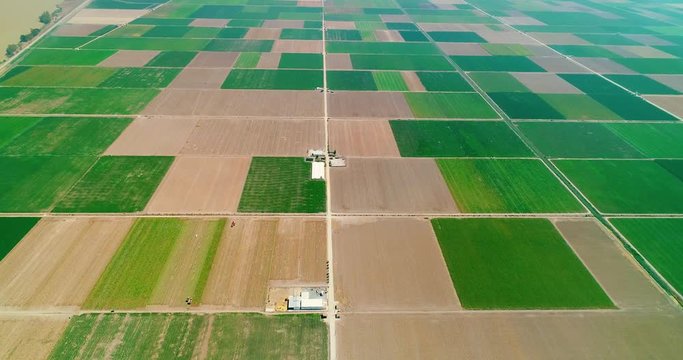 Intensive agriculture in a large farm with a lot of fields. This this an issue for the environment and pollution - aerial view with a drone - Agriculture and Landscape concept 4K