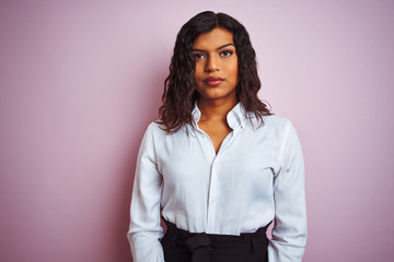Beautiful transsexual transgender elegant businesswoman over isolated pink background with serious...