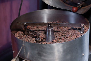 Worker roasting cocoa beans in a chocolate making factory