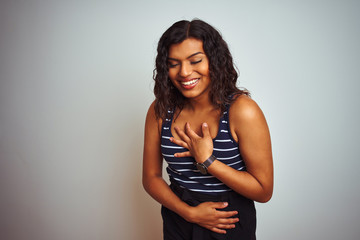 Transsexual transgender woman wearing striped t-shirt over isolated white background smiling and laughing hard out loud because funny crazy joke with hands on body.