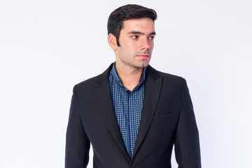Face of young handsome Persian businessman in suit thinking