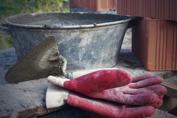 Mason bricklaying background with trowel and clay brick blocks