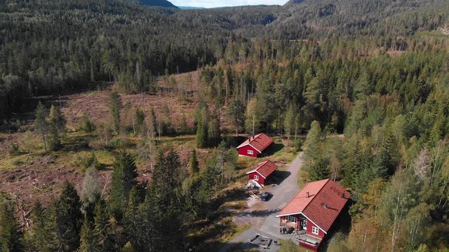 Aerial view over Heisetra cabins with lots of beautiful pine trees and forest surrounding the cabins, in Kodal, Norway